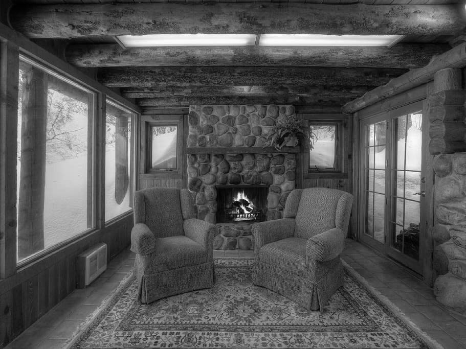 two chairs near a fireplace in a log cabin in Sundance Utah