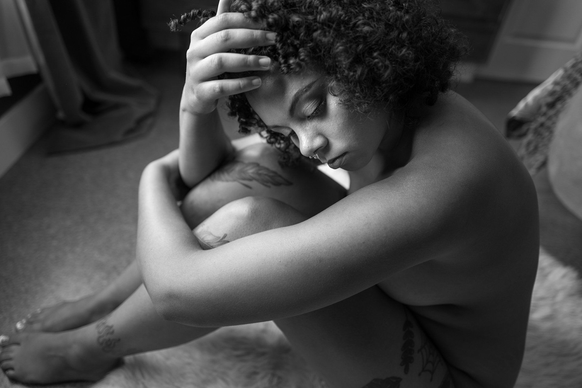 Utah Boudoir Studio woman sitting on the floor with her hands around her knees