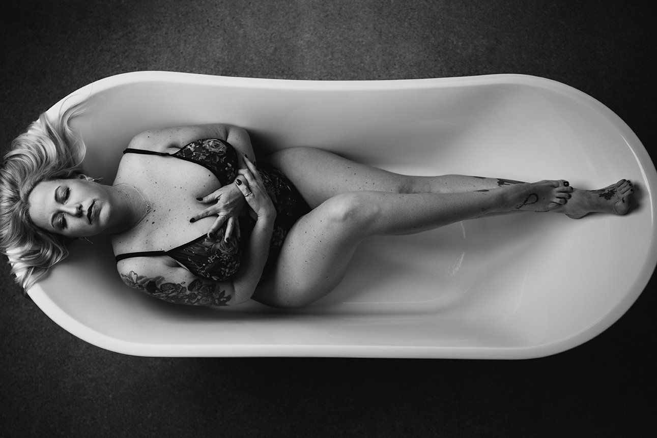 Salt Lake City Boudoir woman laying in a bathtub with her eyes closed