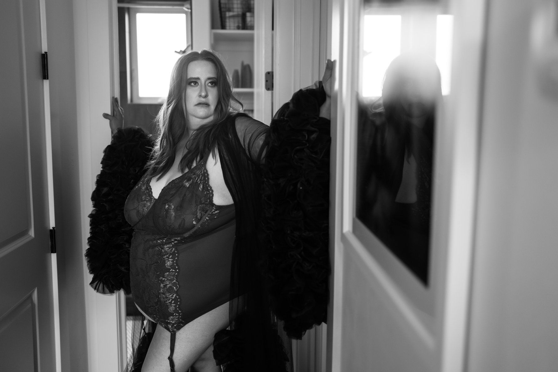 Best Utah Boudoir Photography woman standing in a corridor wearing a large robe