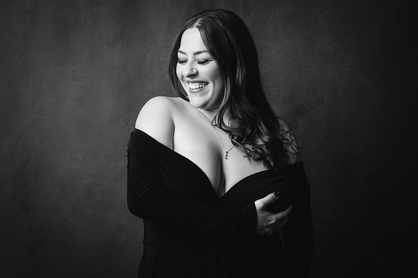 the best photography studio in utah woman in a black dress smiling