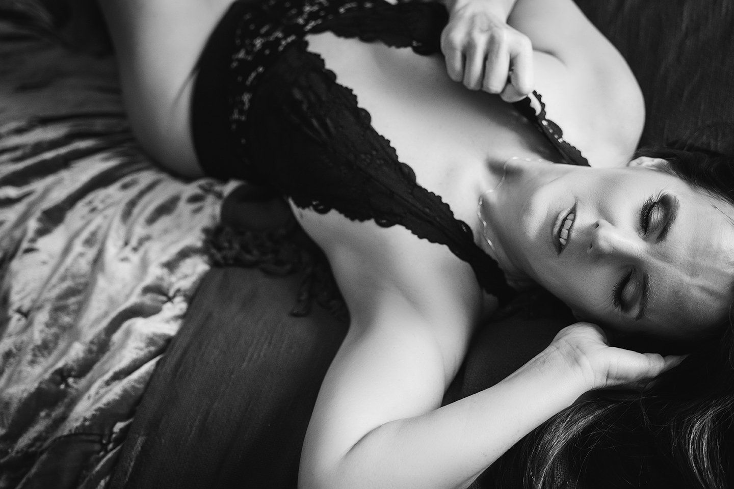 boudoir image of woman in lingerie lying on bed