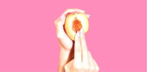 woman fingering peach