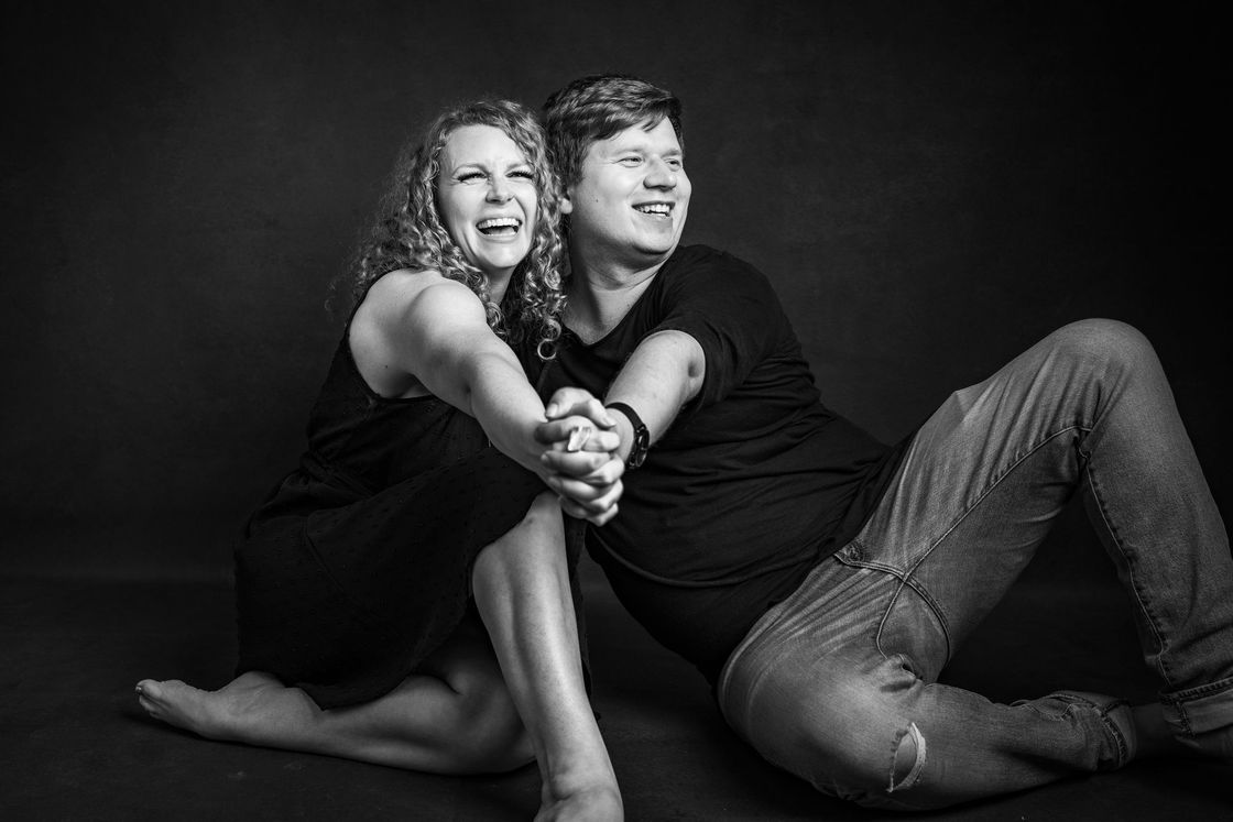 Man and woman sitting on the floor in black and white