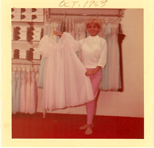 A photo of a woman holding a white dress dated october 1967