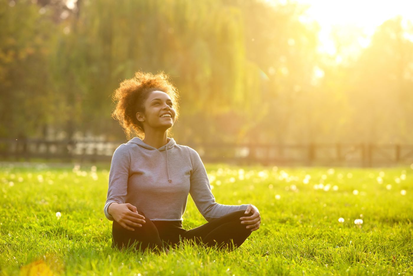 A Woman Is Sitting in A Field — Moving Beyond OK In Marsden, QLD