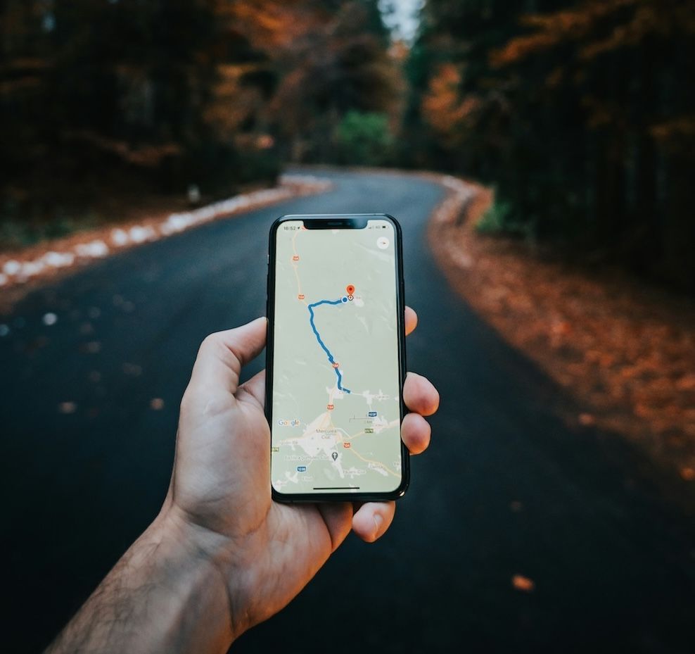 A Person Is Holding a Cell Phone in Front of A Road — Moving Beyond OK In Mount Warren Park, QLD