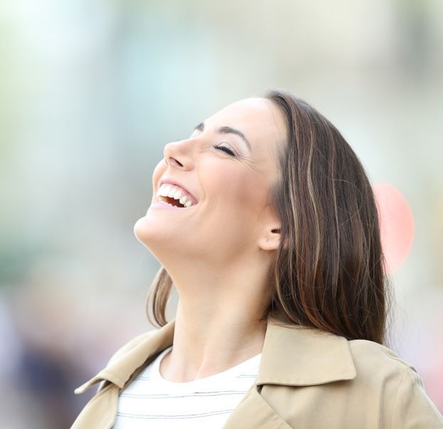 A Woman in A Trench Coat Is Laughing — Moving Beyond OK In Mount Warren Park, QLD