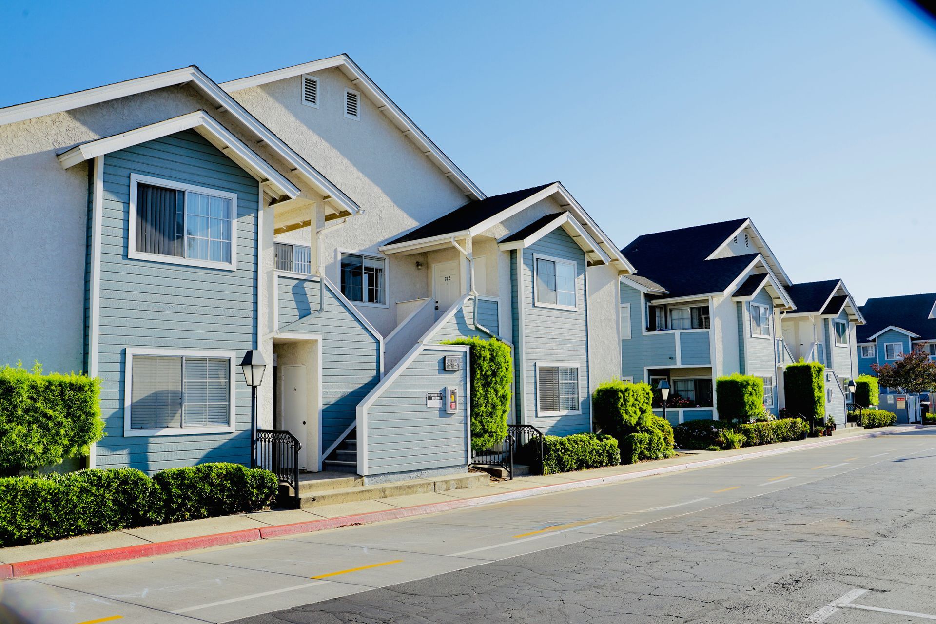 A row of apartment buildings on a sunny day