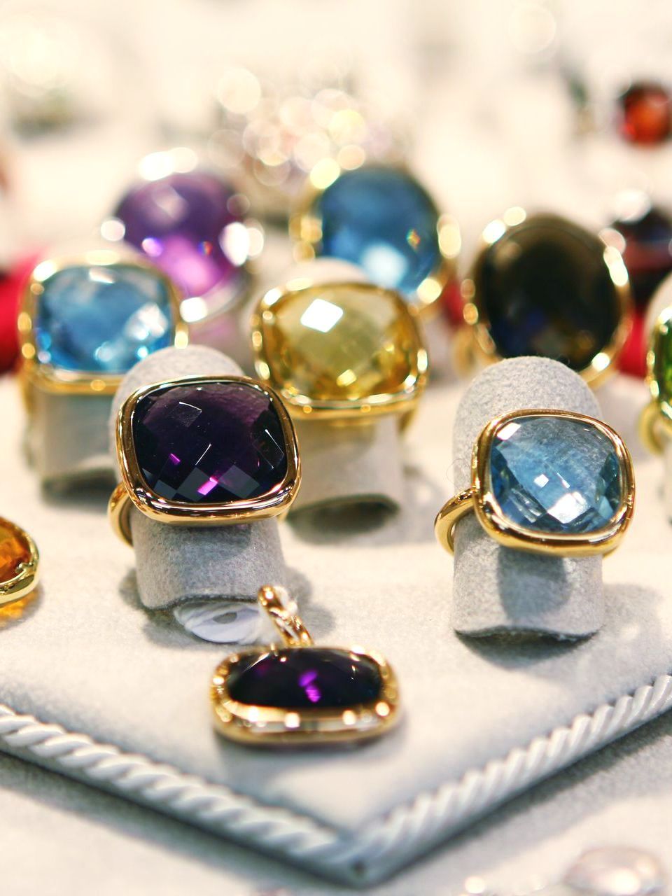 A Collection of Rings With Large, Colorful Stones. Sell Your Jewelry in an Online Auction Today.