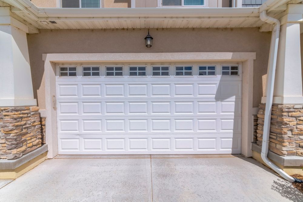 Front-facing single-car driveway with stone trim edges installed by Elite Form Concrete in Cedar Fort, UT.