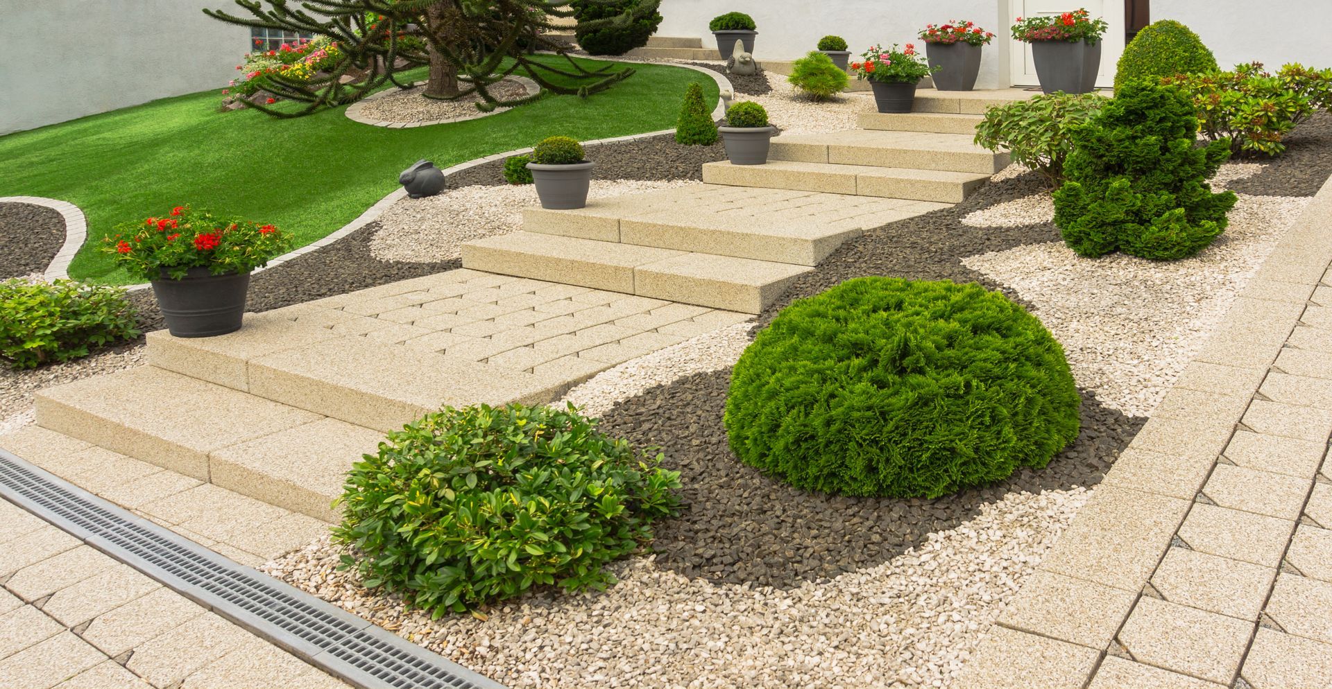 Modern tiered patio with landscaping and stone details, worked on by Elite Form Concrete in Rio Rancho, NM.