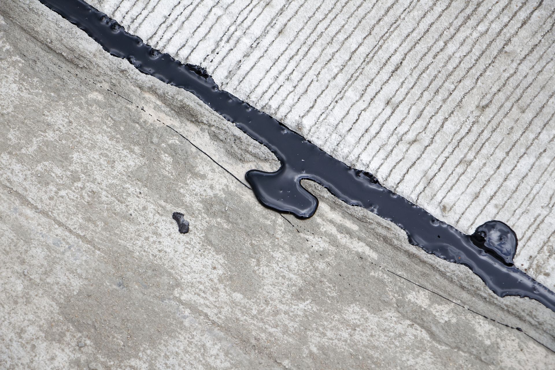 Crack sealant applied to control joint in concrete slab, worked on by Elite Form Concrete in Eagle Mountain, UT.