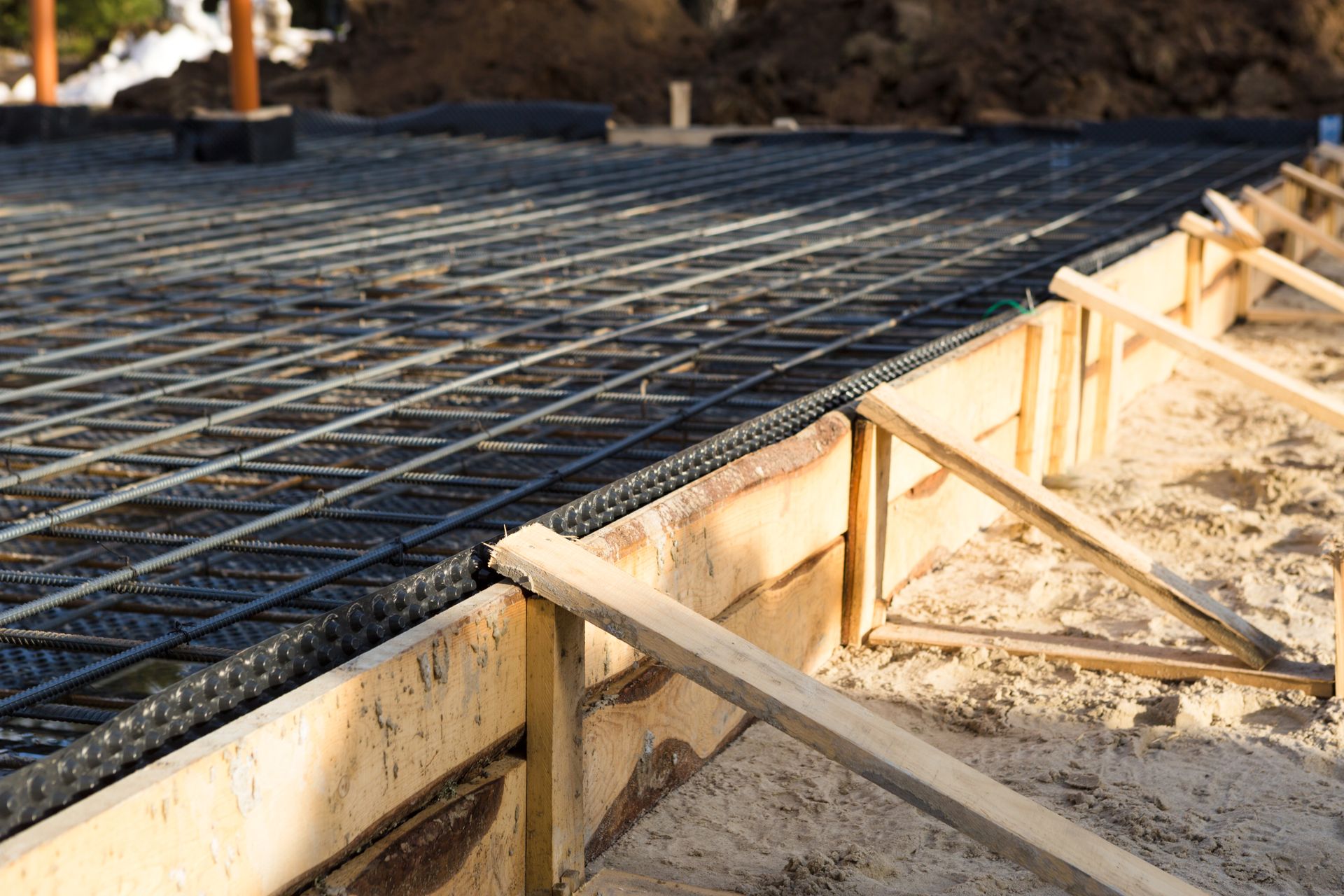 Steel rebar laid in wood-formed slab ready for pour, worked on by Elite Form Concrete in Rio Rancho, NM.