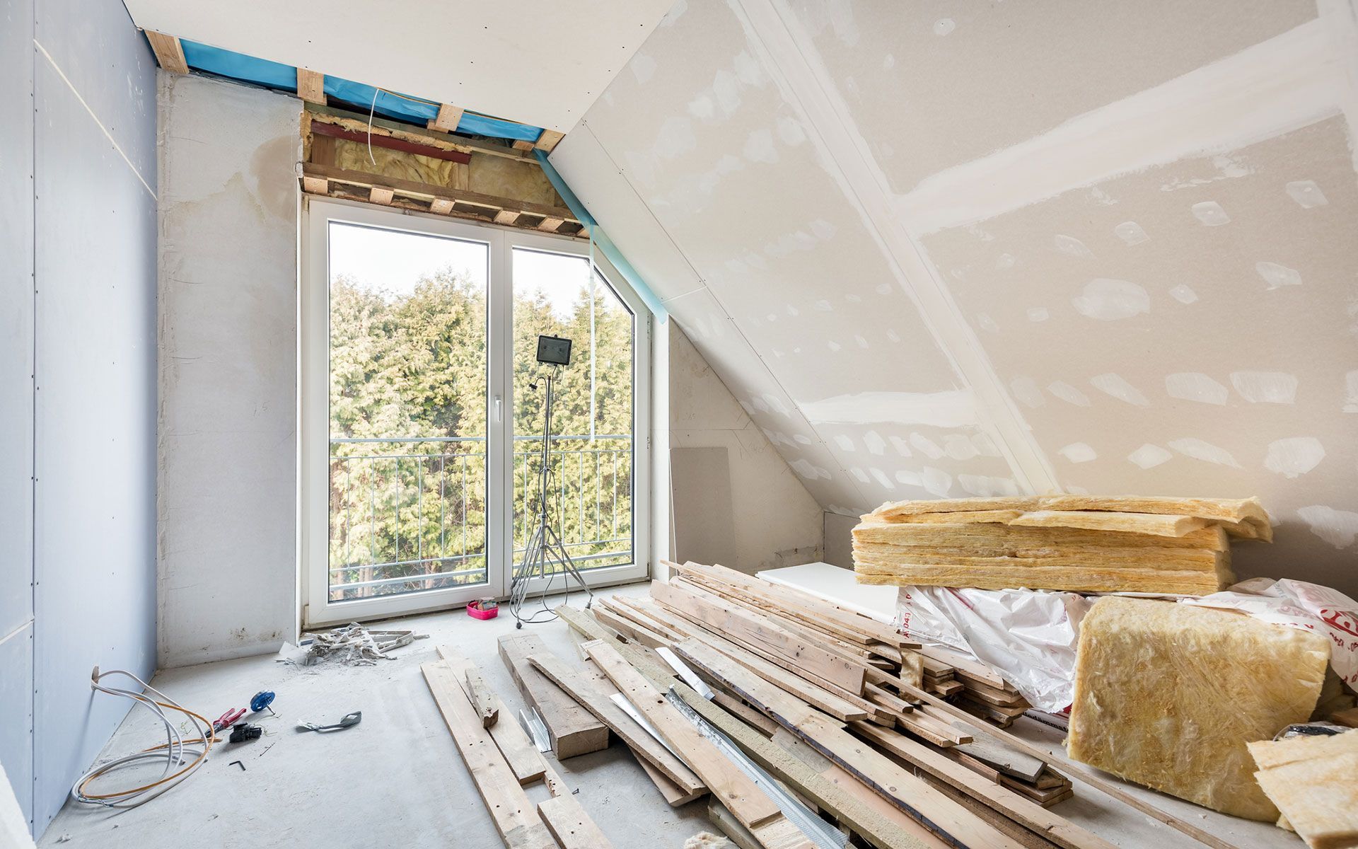 A room under construction with a lot of wood and a window.