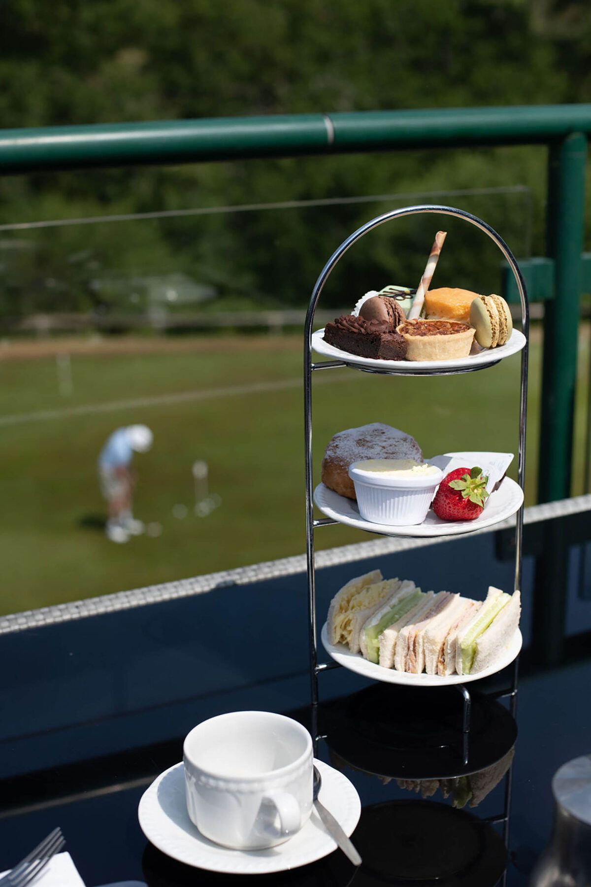A tray of food on a table with a view of a golf course in the background.