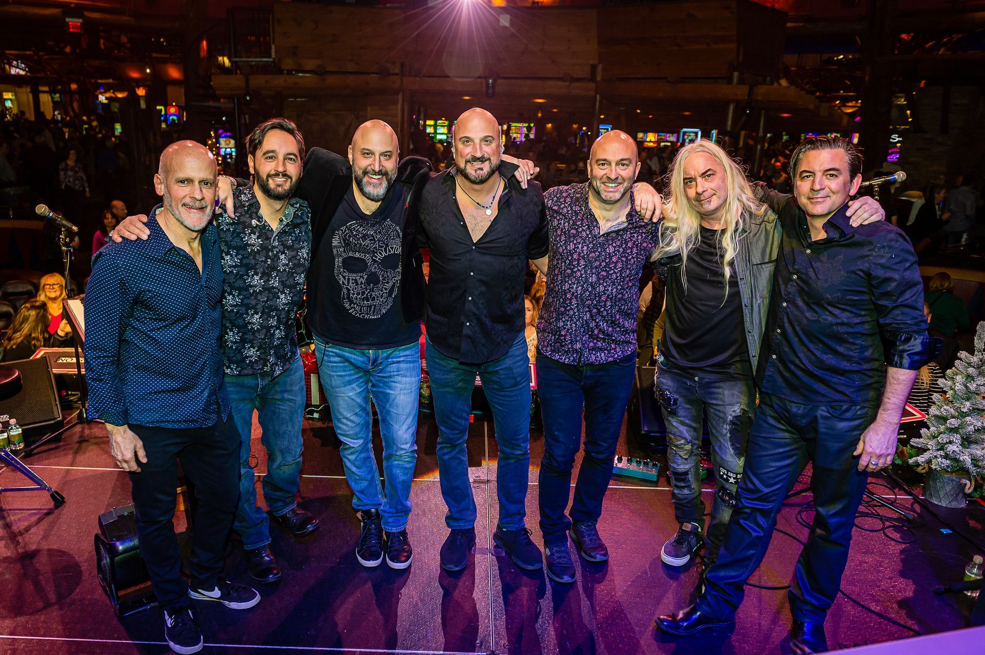 A group of men are posing for a picture on a stage.