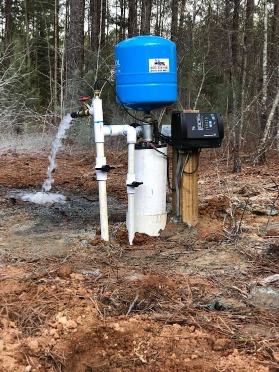 A water pump is being installed in the middle of a forest.