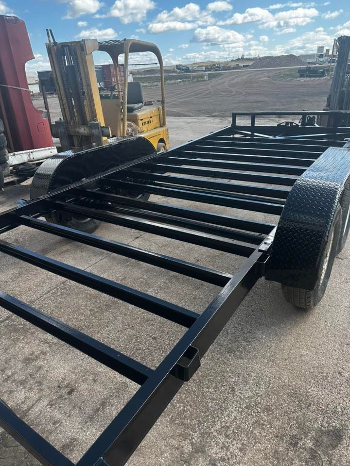Modern office with white desks, black chairs, and computers