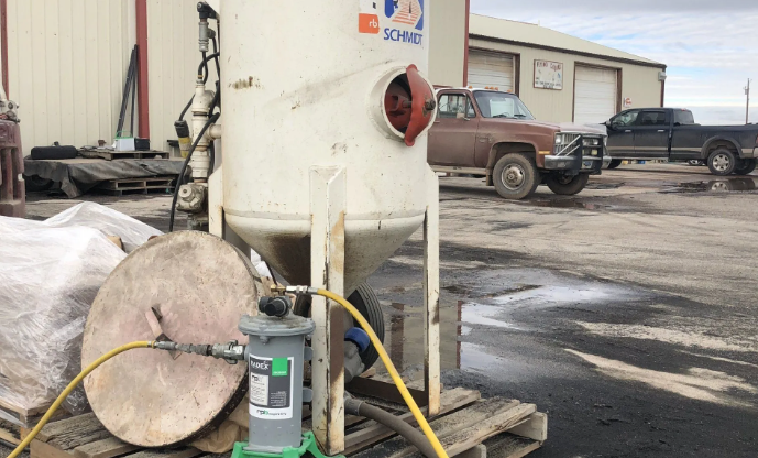 A cozy window nook with neutral pillows and a knitted blanket