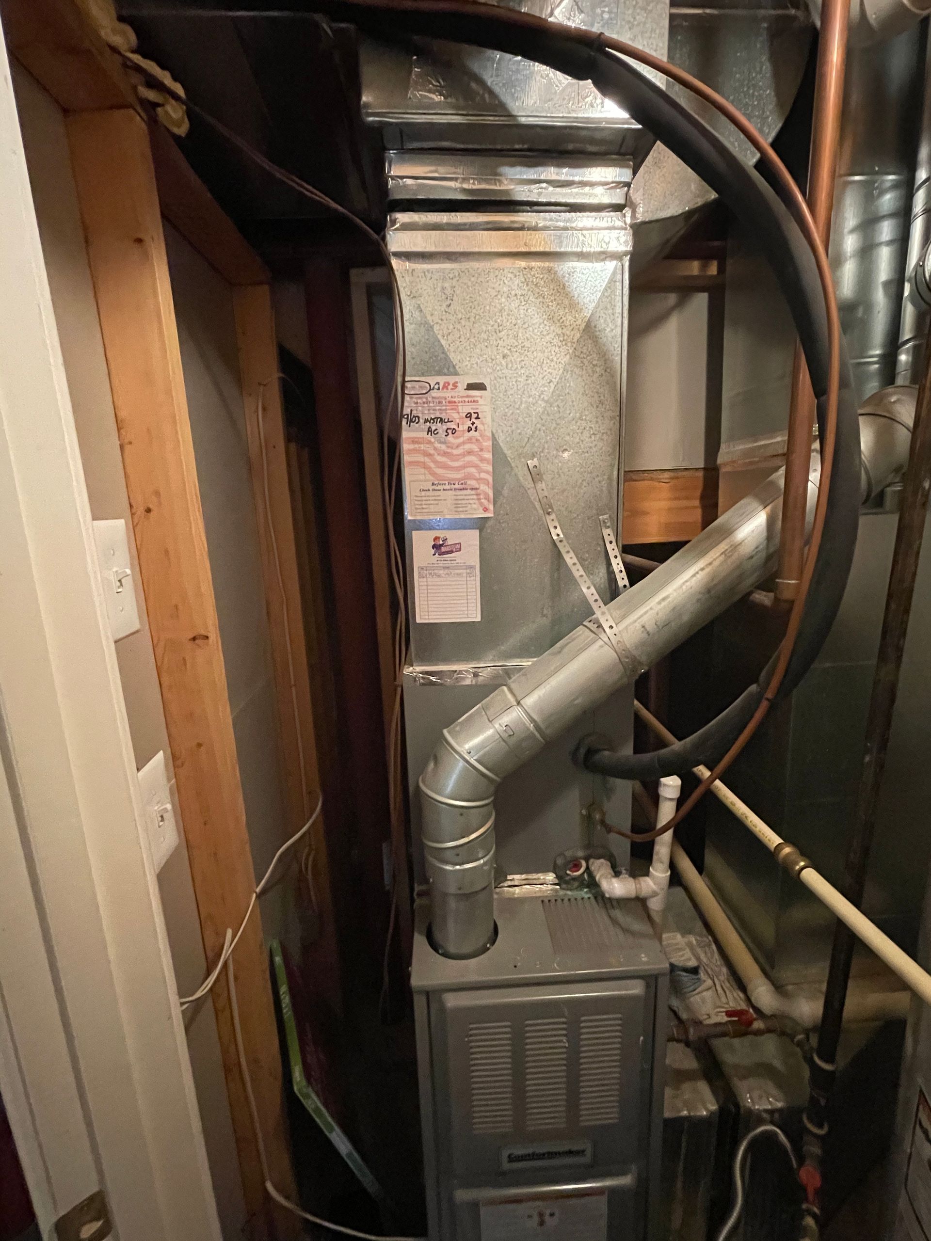 A picture of an air conditioner in a basement.