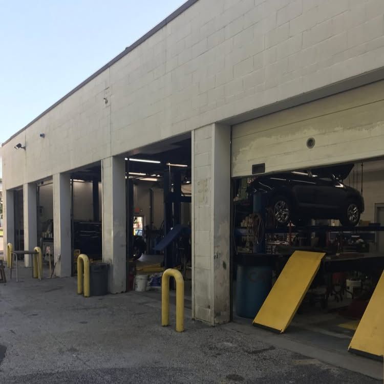 Auto Repair Service Bays With Vehicles Inside Shop | My Family Car Care Center