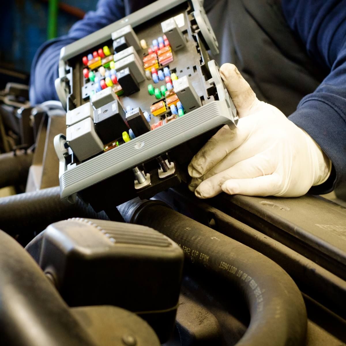 Technician Inspecting Vehicle Fuse Box And Electrical System | My Family Car Care Center