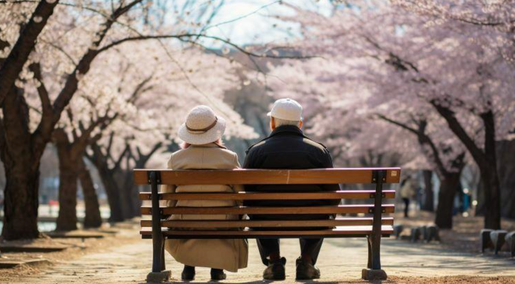 一對年長的夫婦坐在公園長椅上