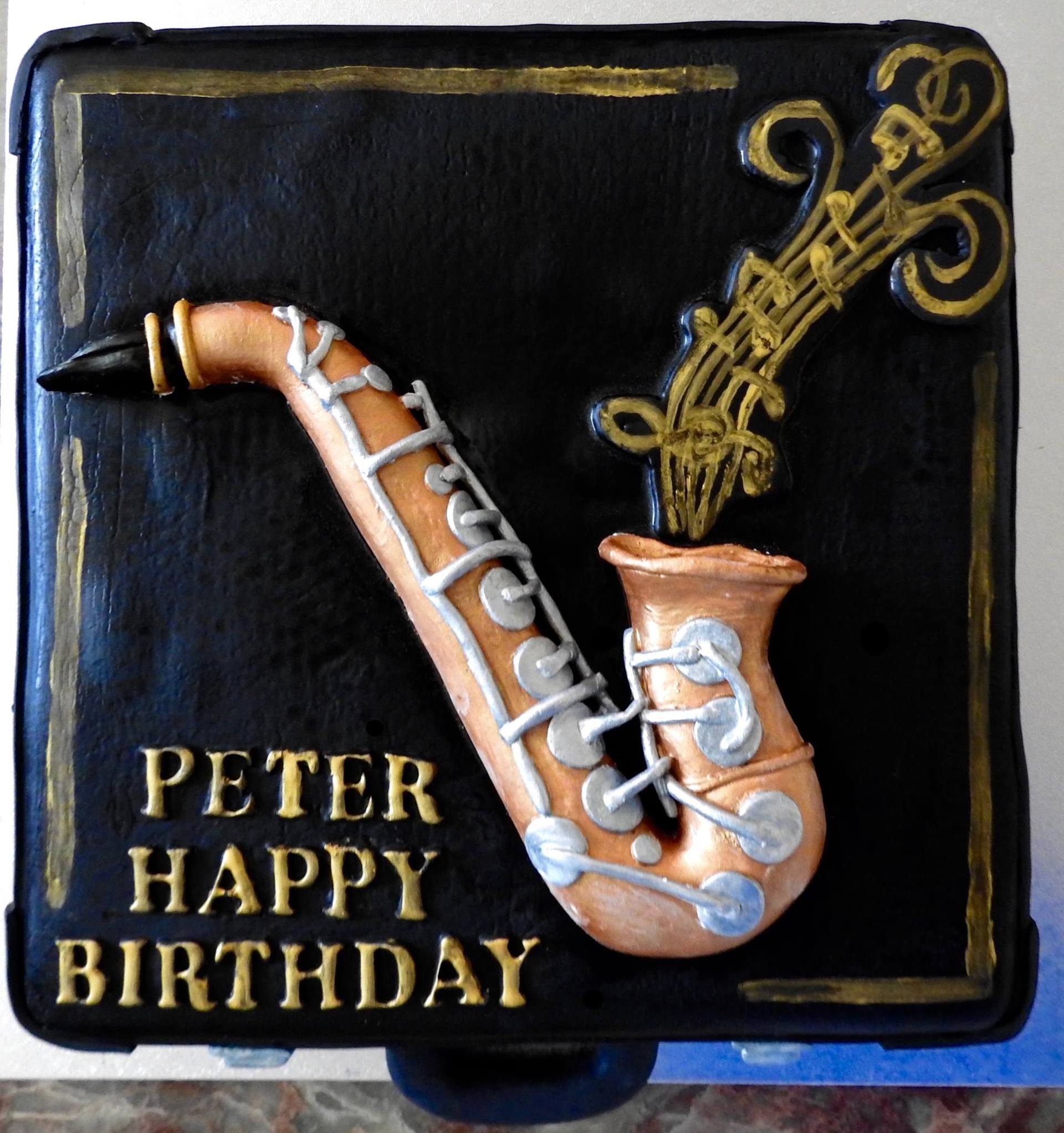 Birthday Cake Black square music case with saxophone.