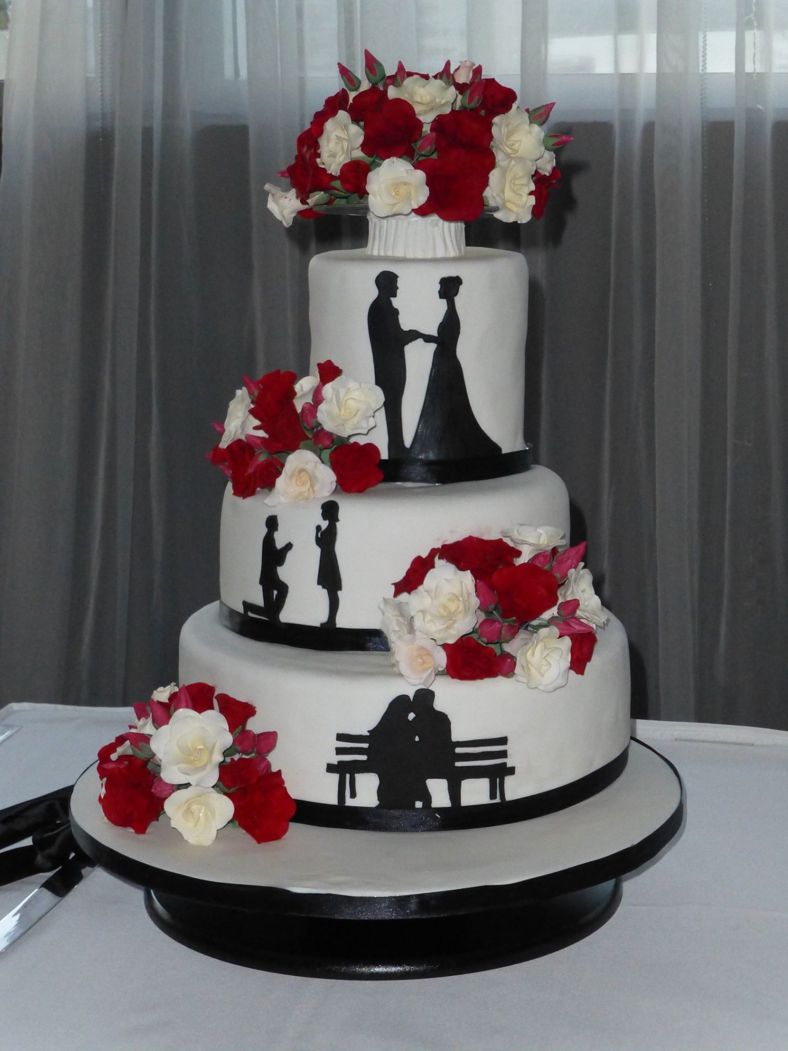 3 tiered Wedding Cake with red and white sugar roses and black silhouettes wedding figurines