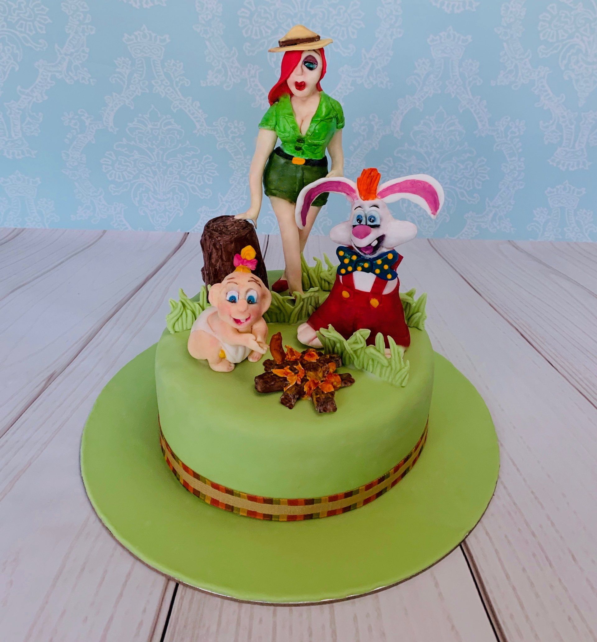 Birthday Cake With A Cute Handsculpted Sugar Cartoon Rabbit, Baby and Ranger At A Campsight.