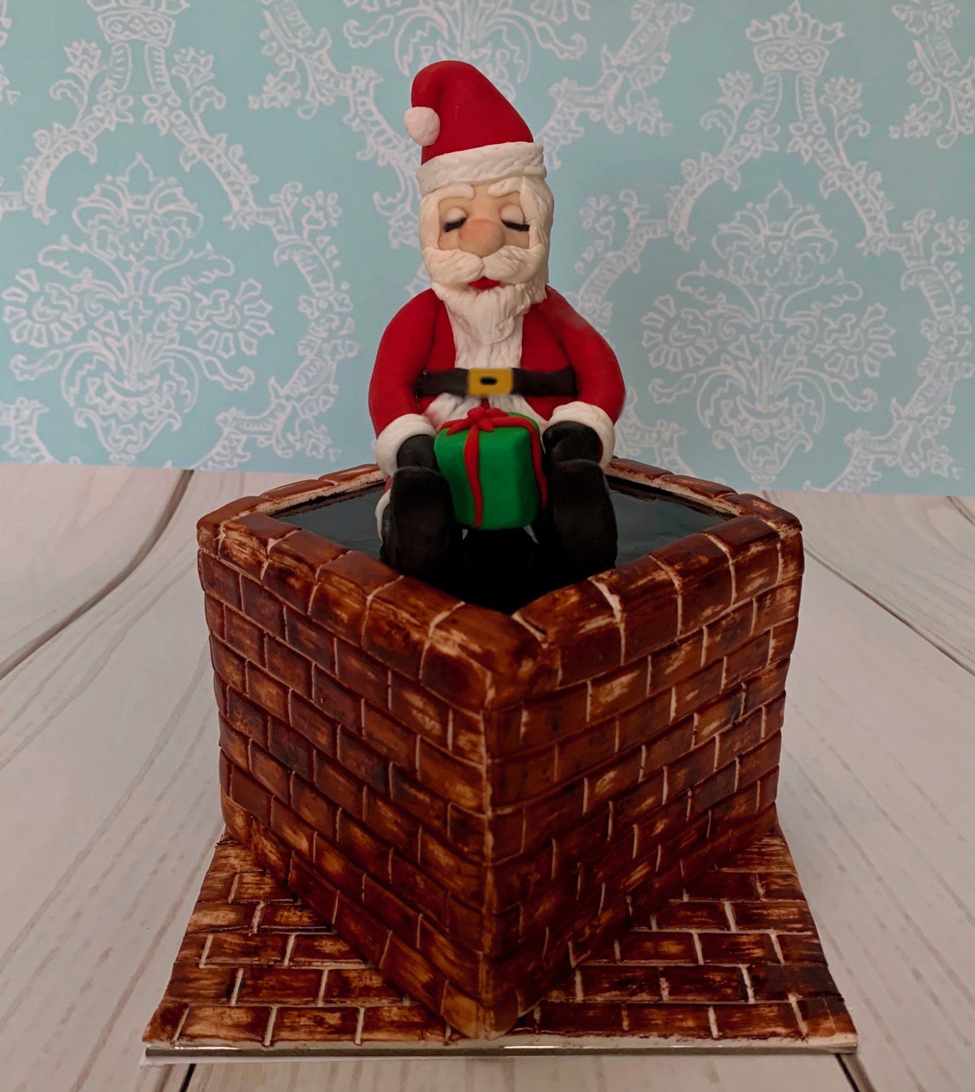 Christmas Fruit Cake decorated to look like a brick chimney and a sleepy santa on top.