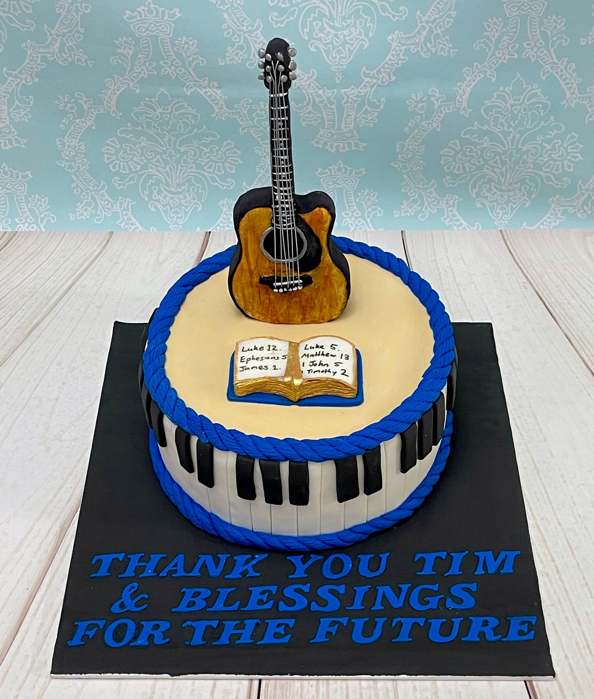 Thank-you Cake Port Macquarie with fondant piano keyboard around the sides. Fondant acoustic Guitar and Fondant Bible. 