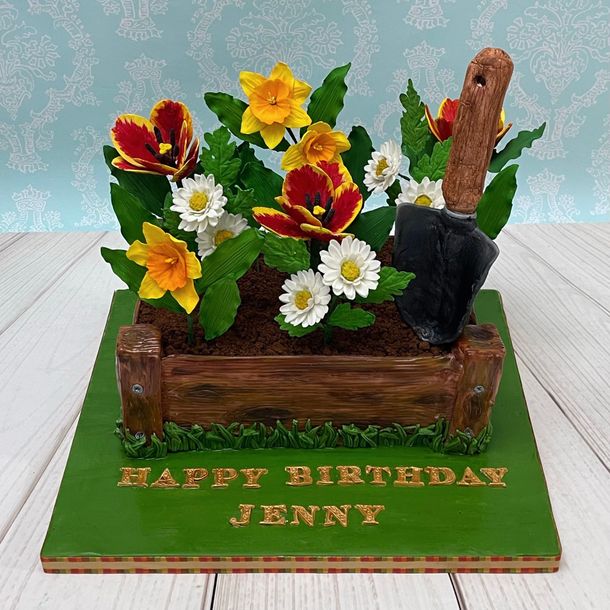Birthday Cake in Port Macquarie Decorated To Look Like A Flower Garden Box, With handmade sugar Daffodils, Sugar Tulips, Sugar Daisies, Sugar Leaves and a Hand sculpted Fondant Spade.