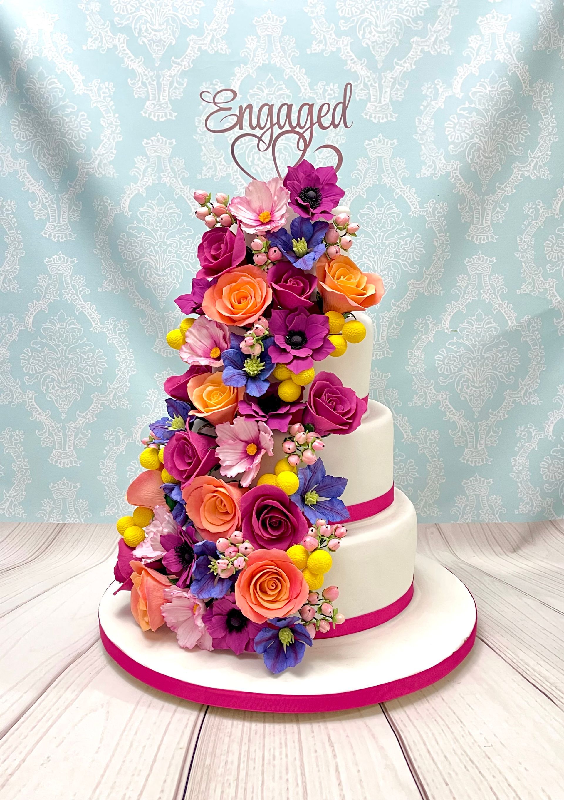 Engagement Cakes Port Macquarie. 4 Tier Cake with a Beautiful Cascade of Bright handmade Spring sugar flowers. 