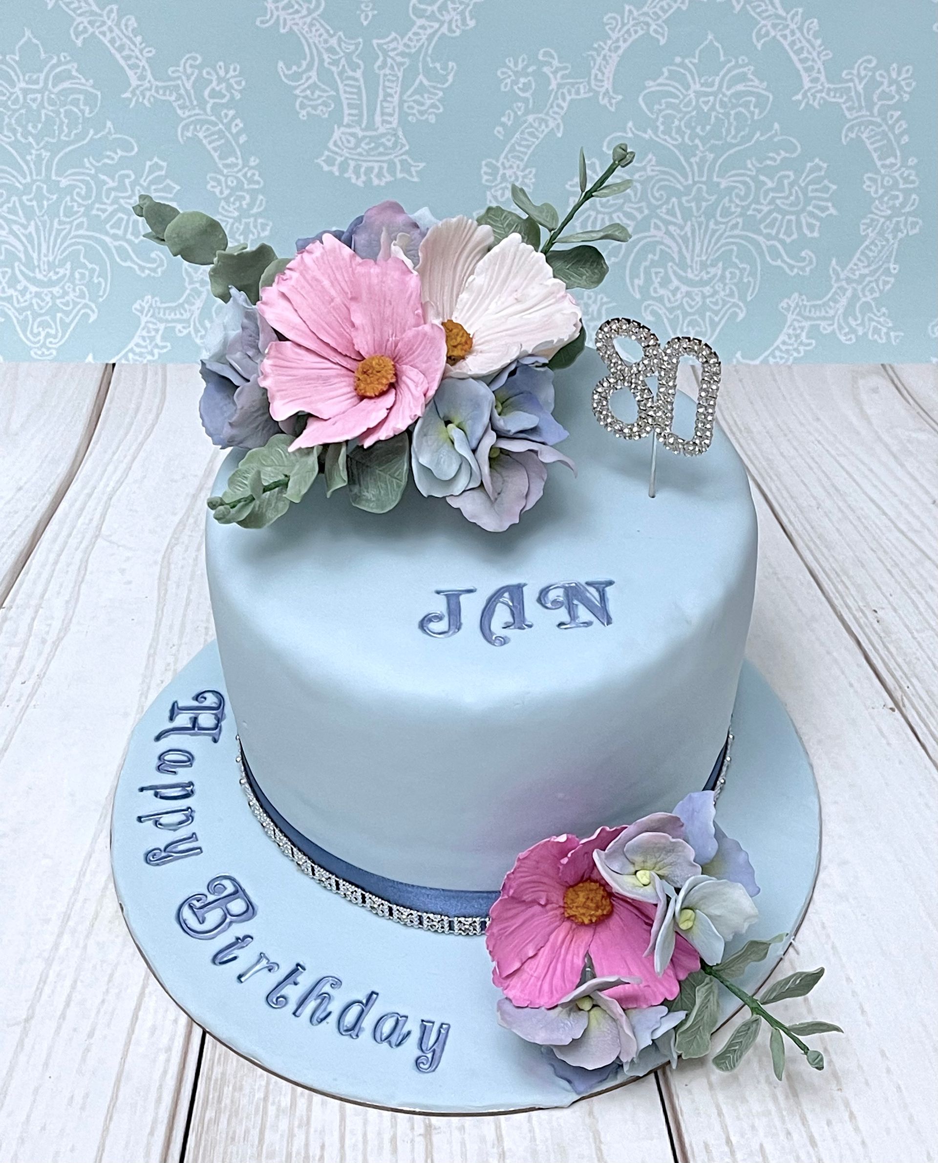 Pretty Pastel Birthday Cake Port Macquarie. In Soft Blue with Handmade Sugar cosmos flowers in whites and pinks and Soft blue Sugar Hydrangeas 