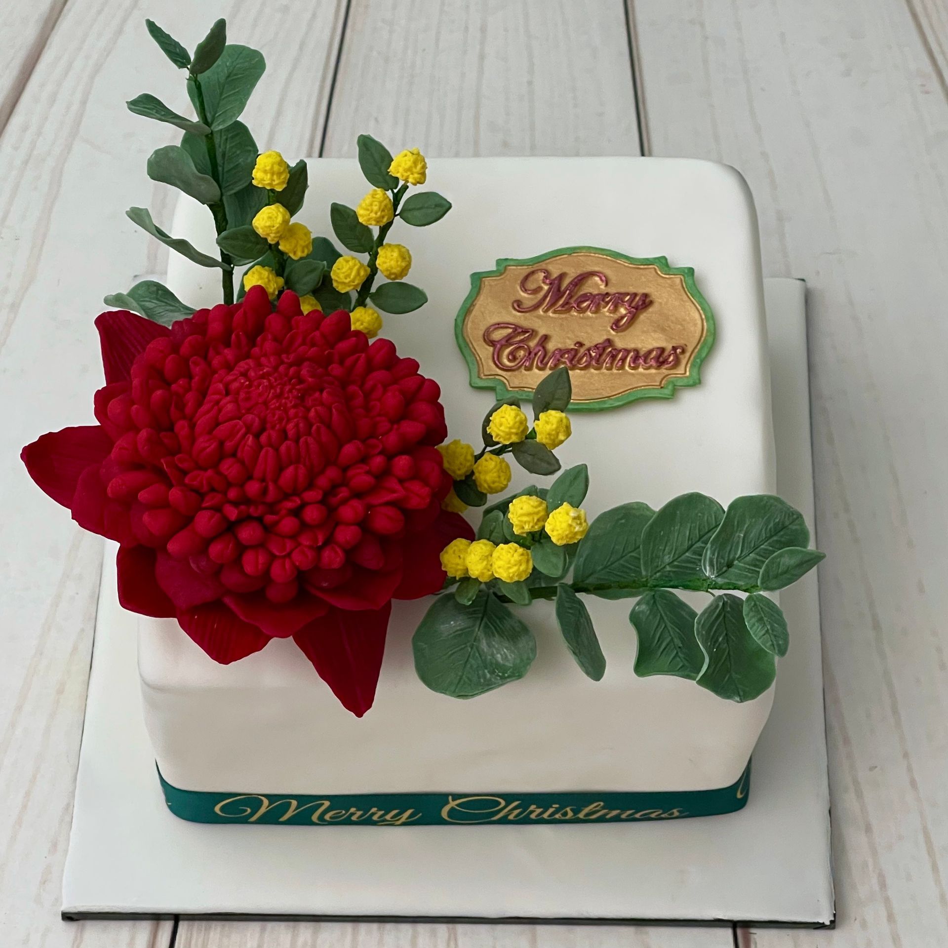 Christmas Cake Port Macquarie with Handmade Australian Sugar Flowers including a Waratah, wattle and gum leaves