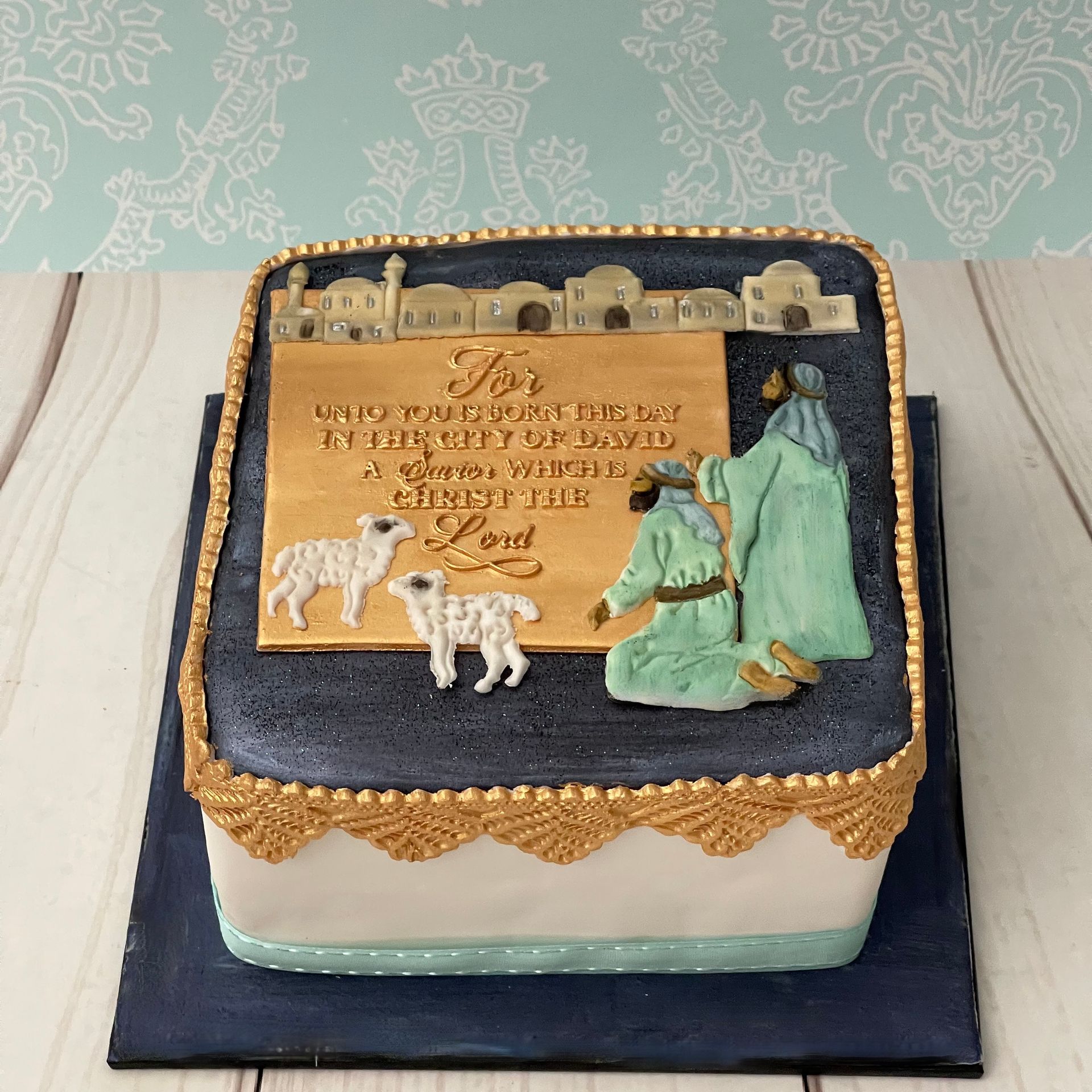 Christmas cake Port Macquarie decorated with shepherds, sheep, and a plaque that says for unto you is born this day in the city of David A Saviour which is Christ the Lord