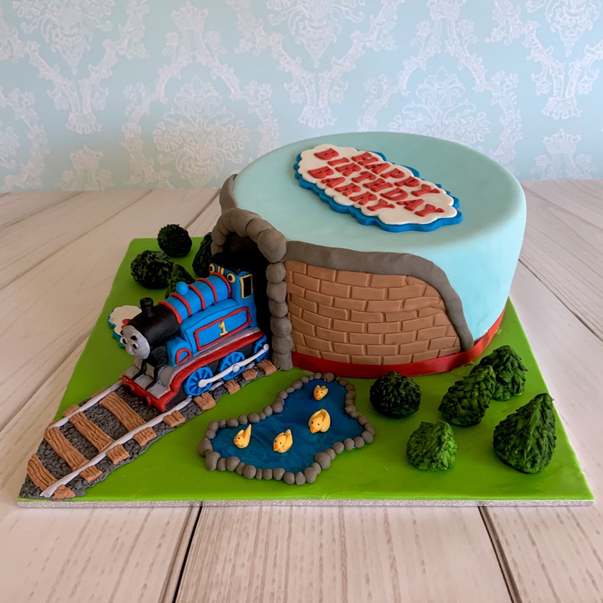 4th Boys Birthday Cake Train coming through tunnel with trees, grass and a duck pond.  Side 2 view