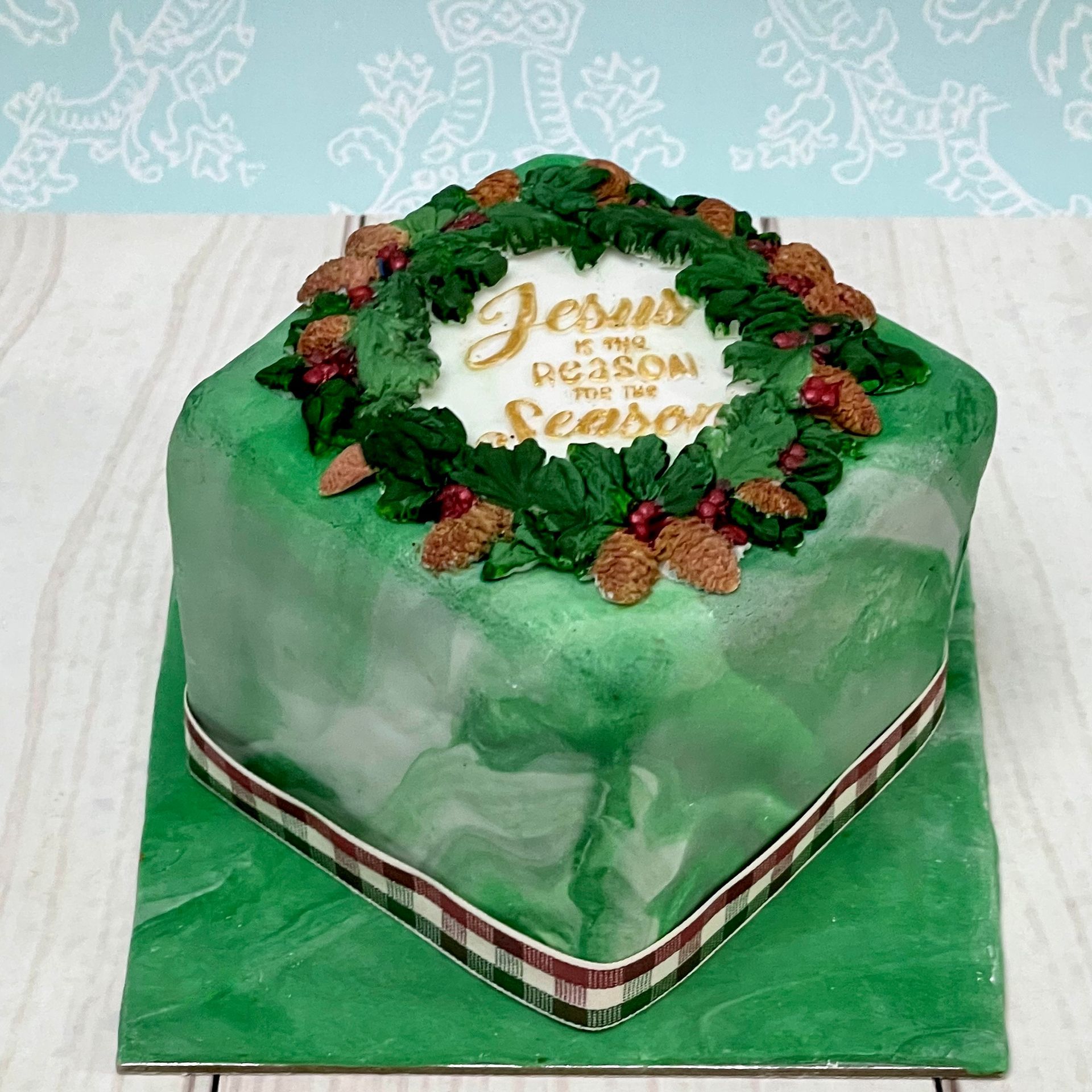 Christmas cake with Green Marbled fondant, Christmas Foliage and the words 