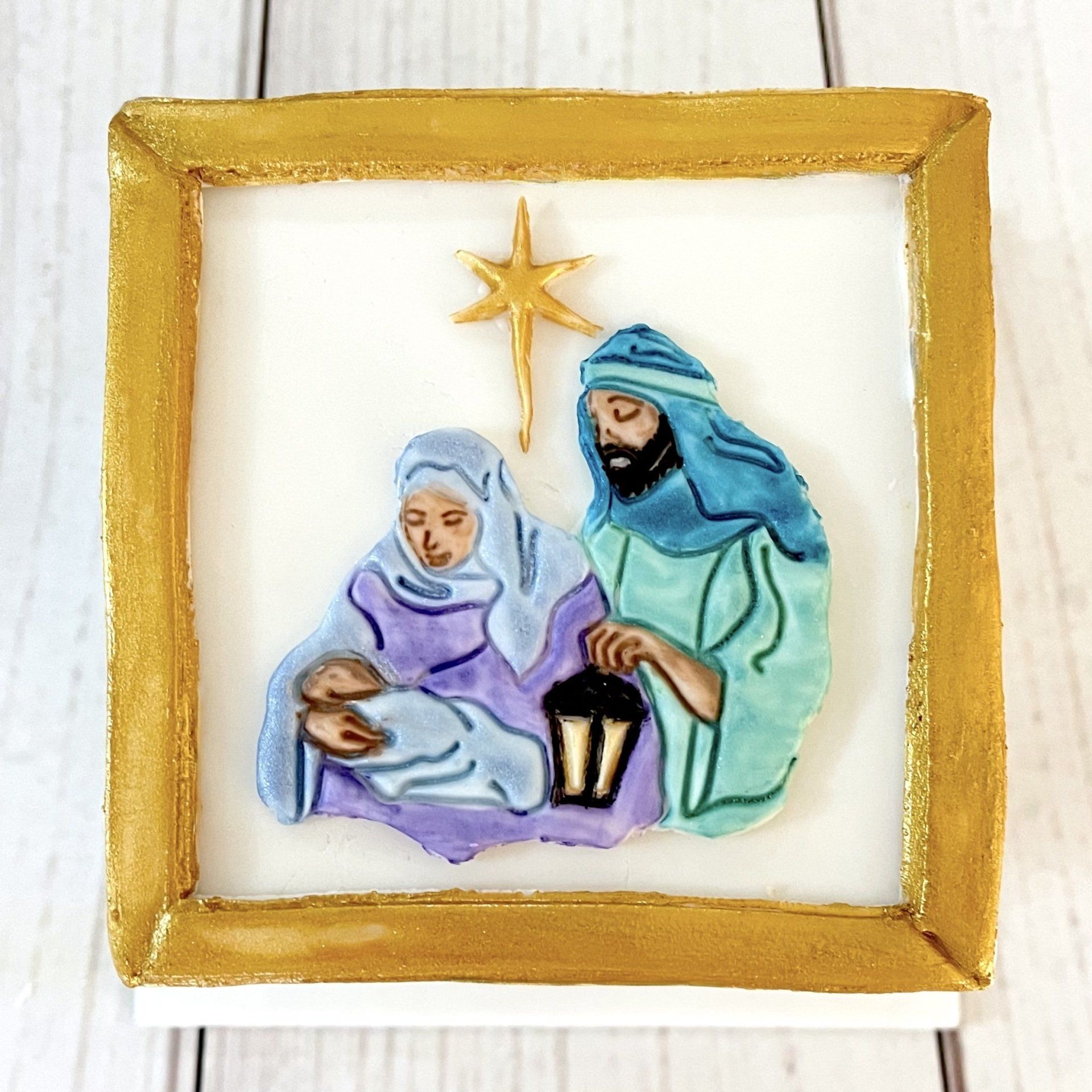 Christmas cake with gold border and a Nativity Scene