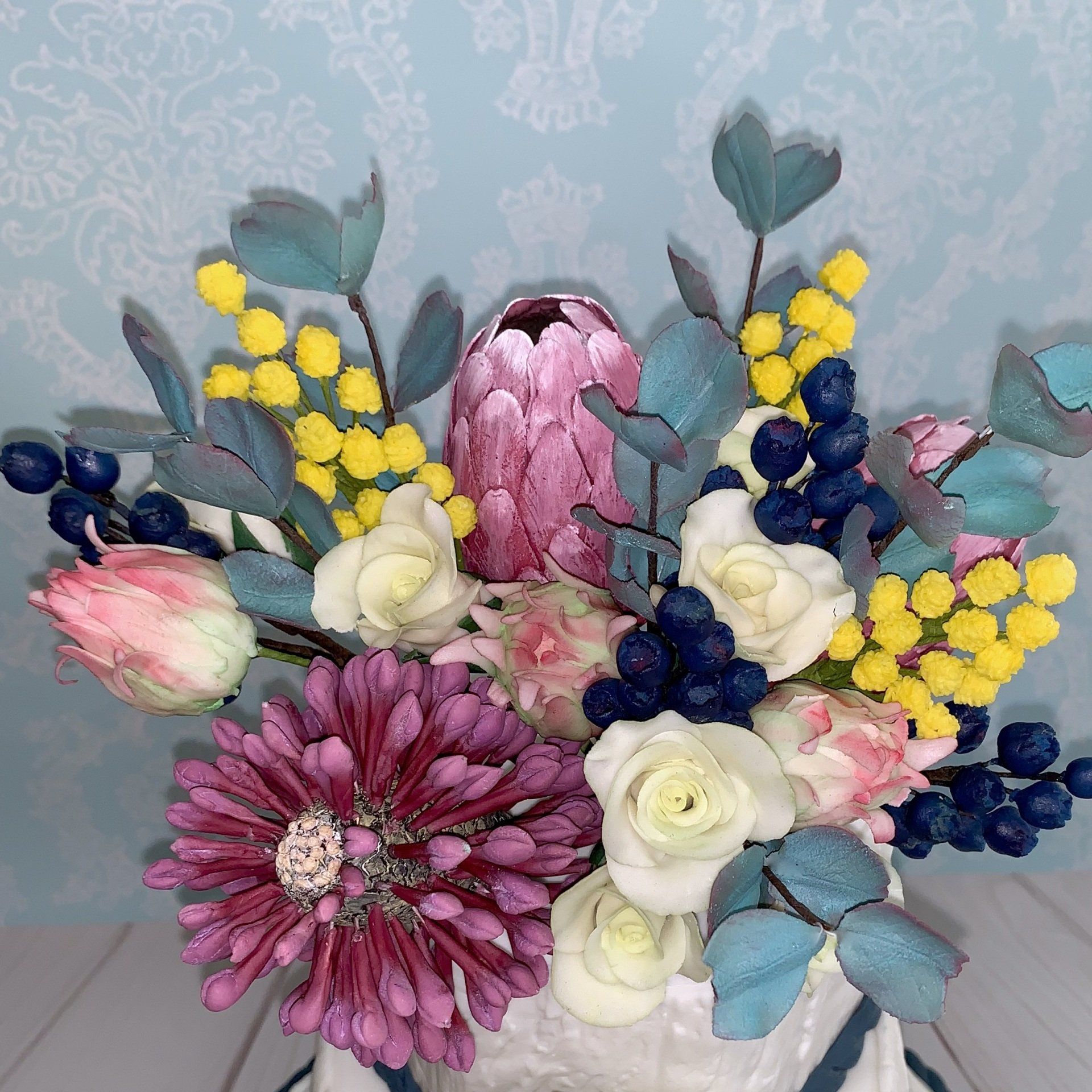 Close up of Australian Native Sugar Flower Wedding Arangement with Sugar Blueberries and Sugar White Roses too.
