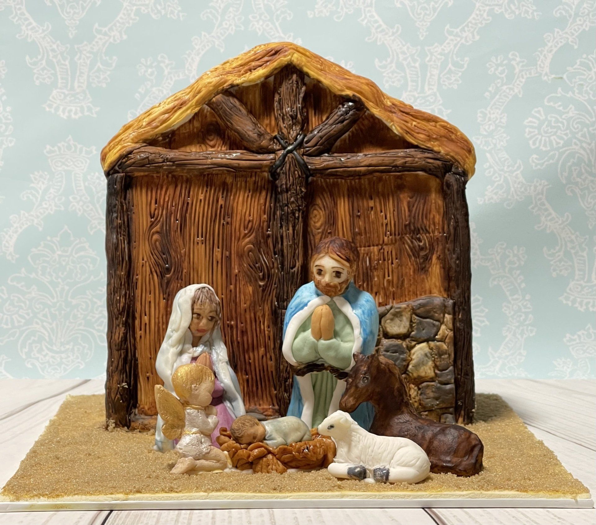 Christmas Cake, nativity stable with a hand sculpted Donkey, Sheep, Mary, Joseph and Baby Jesus,