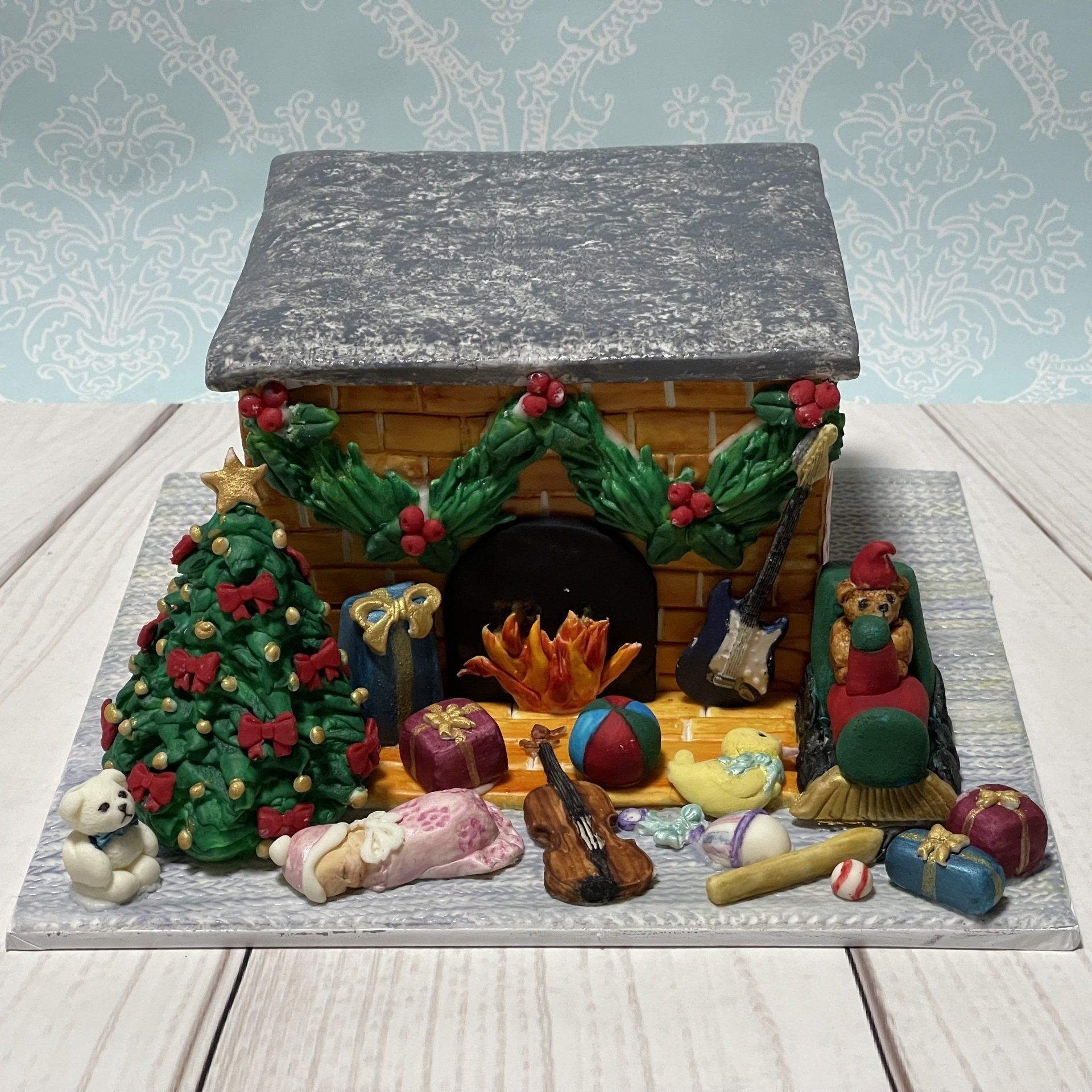 Christmas Cake Made to look like a fireplace on Christmas morning with fondant toys and fondant Christmas tree.