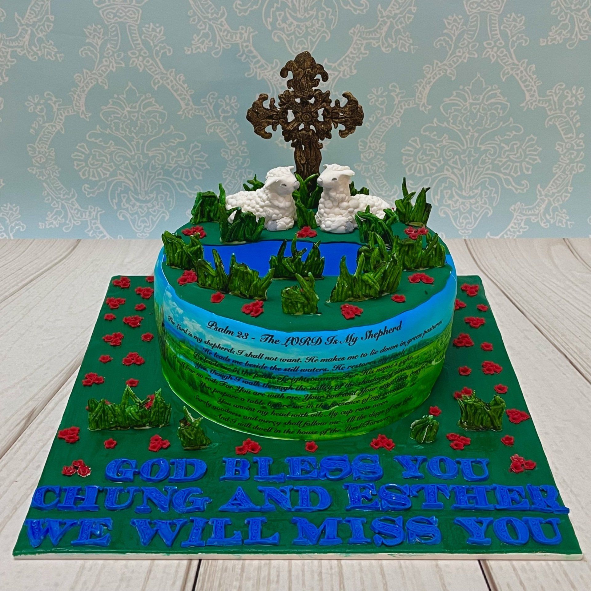 Christian Farwell Cake, with Fondant cross, Fondant sheep, Fondant Grass, Flowers and Fondant River and The 23rd Psalm Printed Around The Front and Fondant Farwelle Message on the Board.