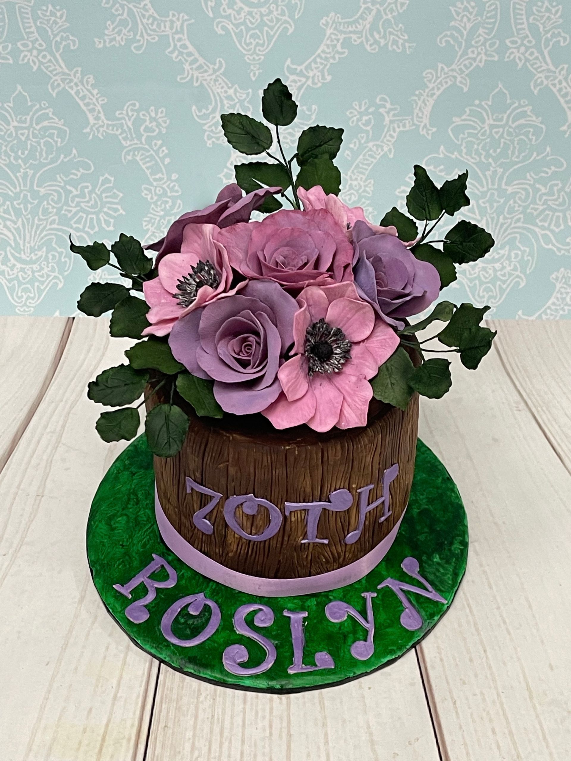 70th Birthday Cake Port Macquarie. Decorated with lots of handmade sugar flowers in pinks and lilacs to look like a wooden barrel of flowers.