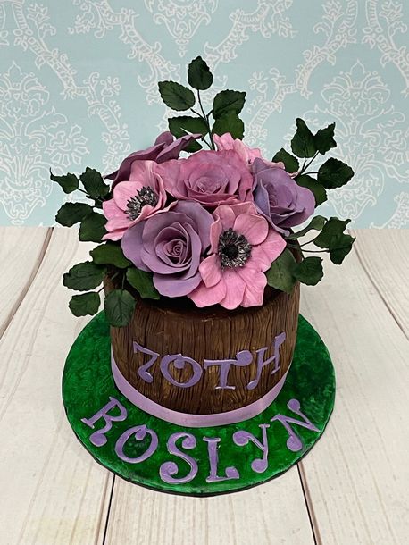 70th Birthday Cake Port Macquarie. Decorated with lots of handmade sugar flowers in pinks and lilacs to look like a wooden barrel of flowers.