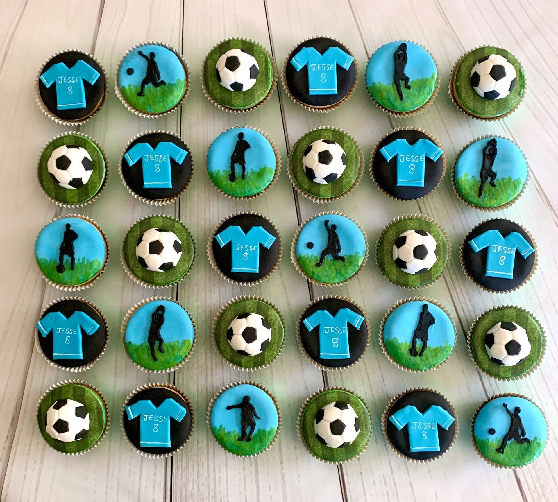 Soccer Themed Cupcakes, With Fondant soccer balls, Soccer silhouettes and ASoccer Jerseys.