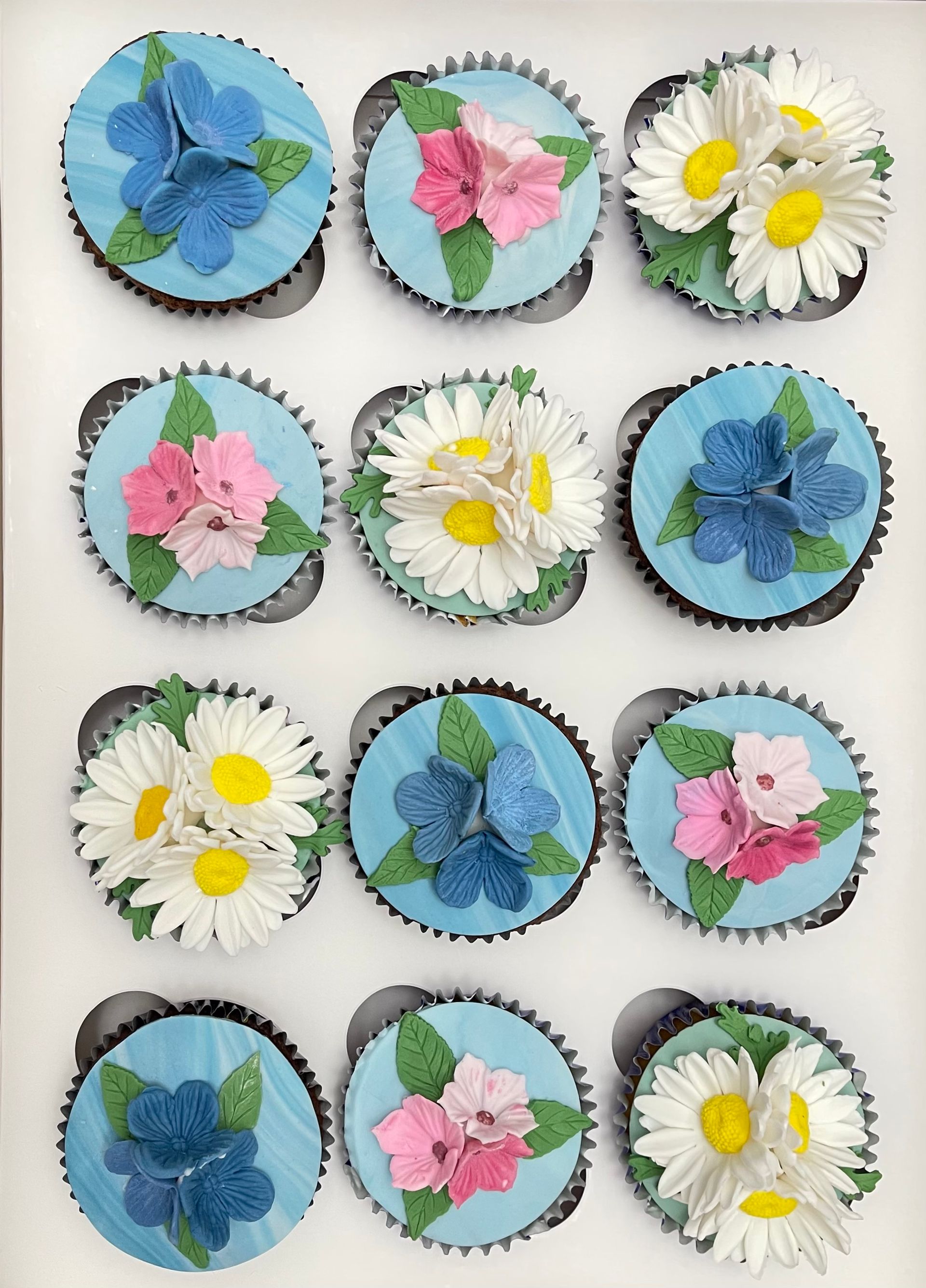 Pretty Cupcakes with Blue fondant and Sugar Flowers.