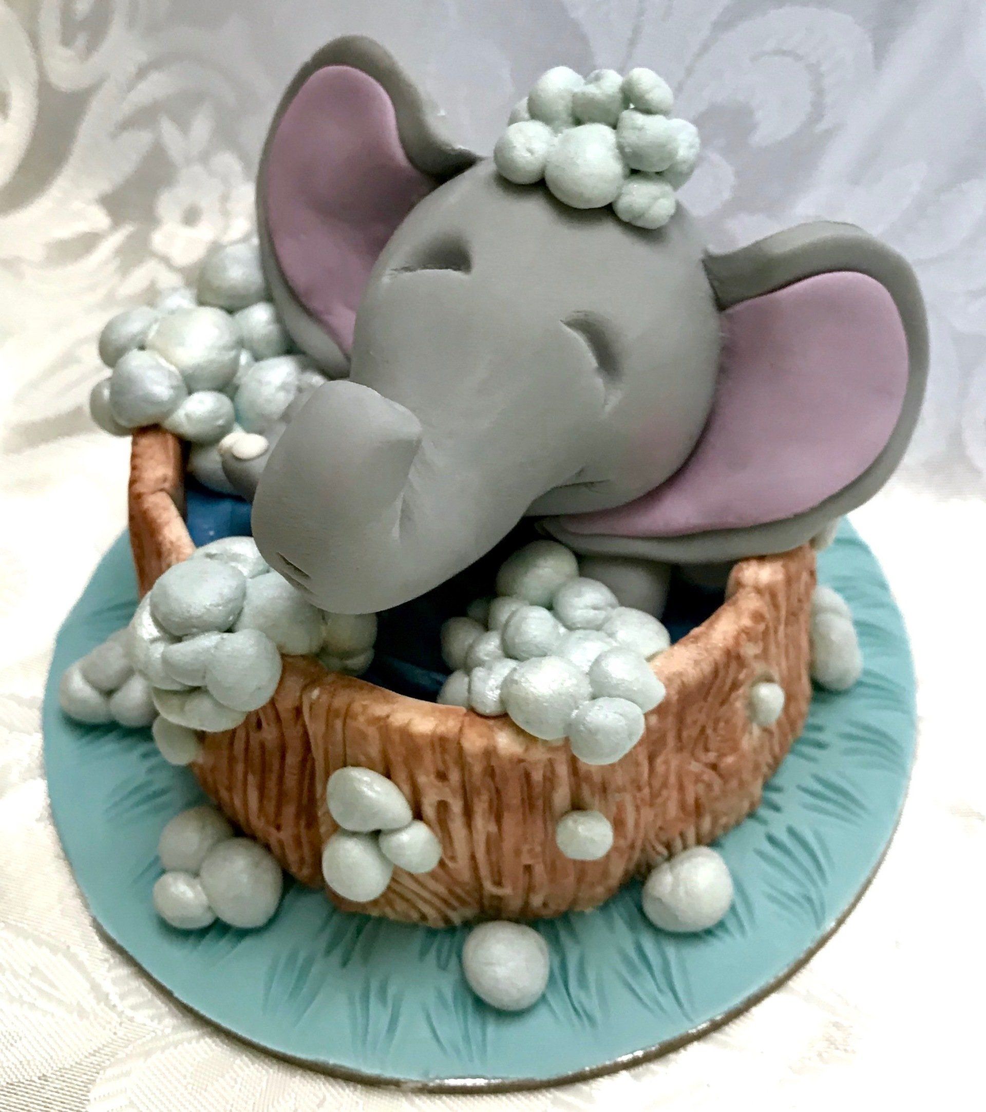 Cute Elephant splashing in a tub cake topper.